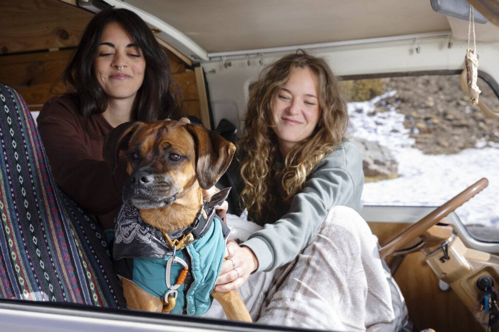 AZAR4 - two female lovers waking up petting their boxer camper van winter trip 1024x683 1 - Dog in a Camper – How to Travel with Your Four-Legged Friend?